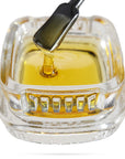 Image of OG Kush CBD Live Resin dripping from a dab tool into a calyx concentrate container