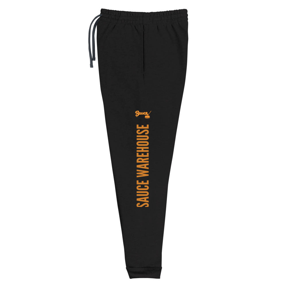 Black Sauce Warehouse x Jerzeez joggers. The outside of each leg features a Sauce Warehouse logo with "Sauce Warehouse" printed along the outside of the leg. Shop CBD concentrates, clothing, and dabbing accessories at Sauce Warehouse