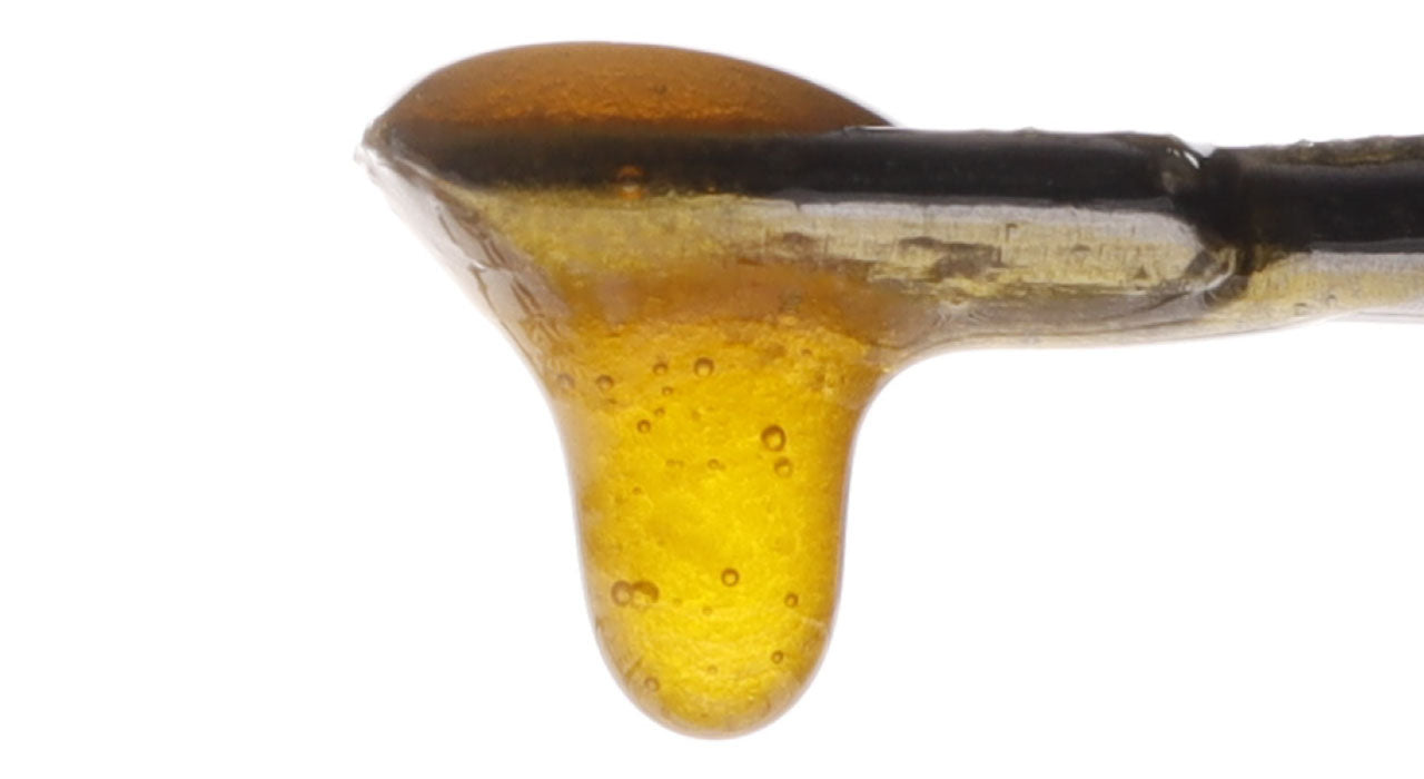 Image of Sour Suver Haze Live Resin dripping from a dab tool.