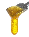 Image of Abacus CBD Live Resin dripping from a dab tool.