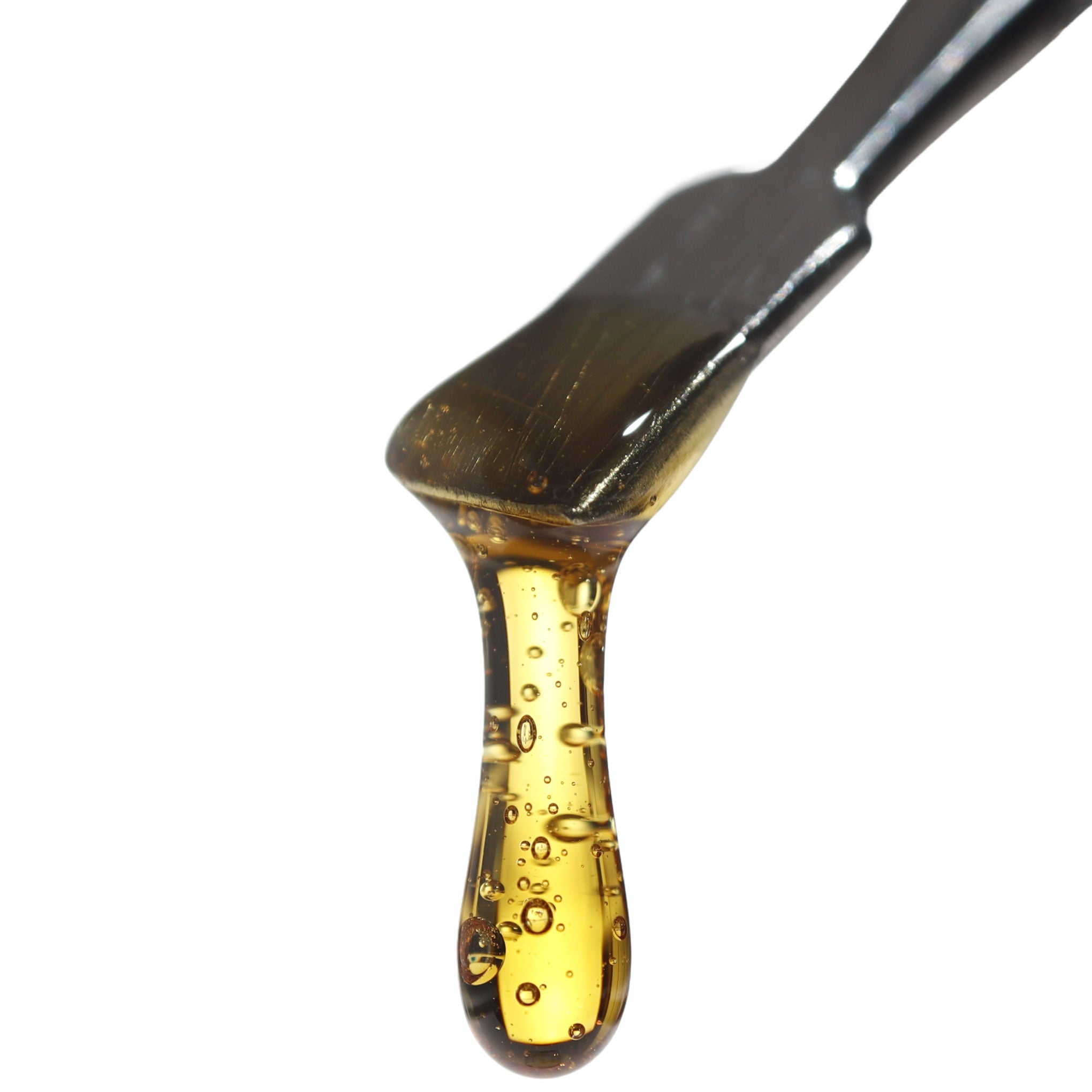 Close up image of Full Spectrum CBD Distillate dripping from a dab tool.