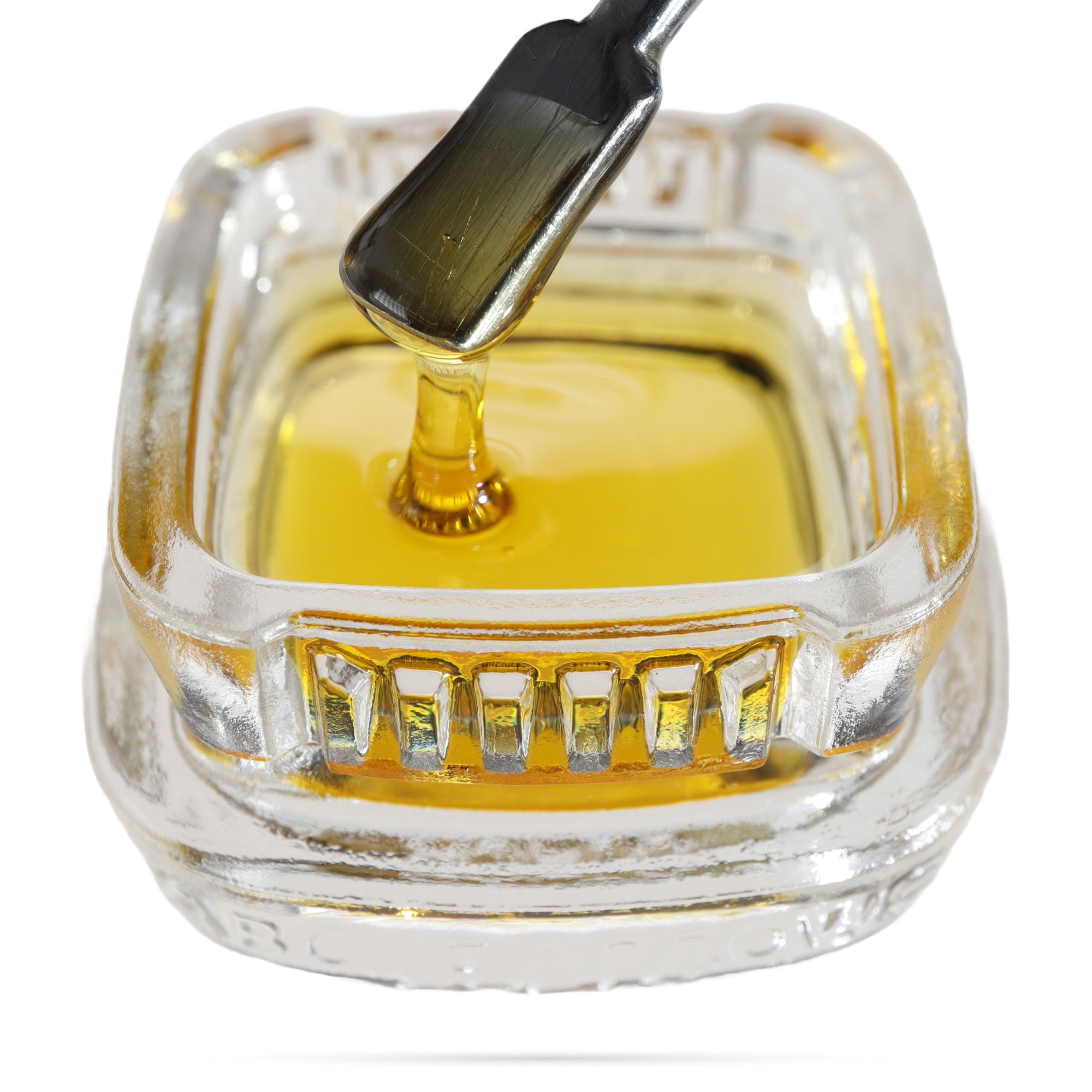 Image of OG Kush CBD Live Resin dripping from a dab tool into a calyx concentrate container