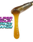 Image of Super Sour Space Candy CBD Live Resin dripping from a dab tool.