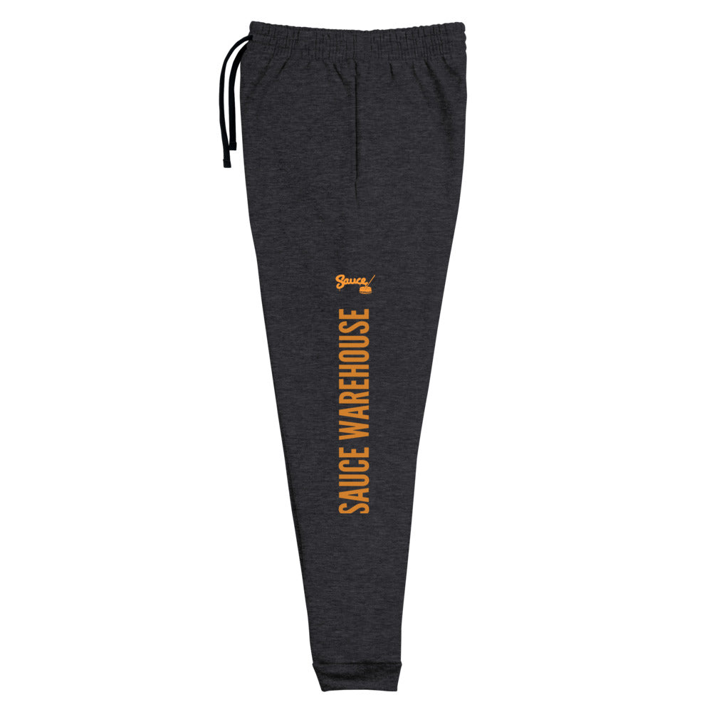 Black Heather Sauce Warehouse x Jerzeez joggers. The outside of each leg features a Sauce Warehouse logo with "Sauce Warehouse" printed along the outside of the leg. Shop CBD concentrates, clothing, and dabbing accessories at Sauce Warehouse