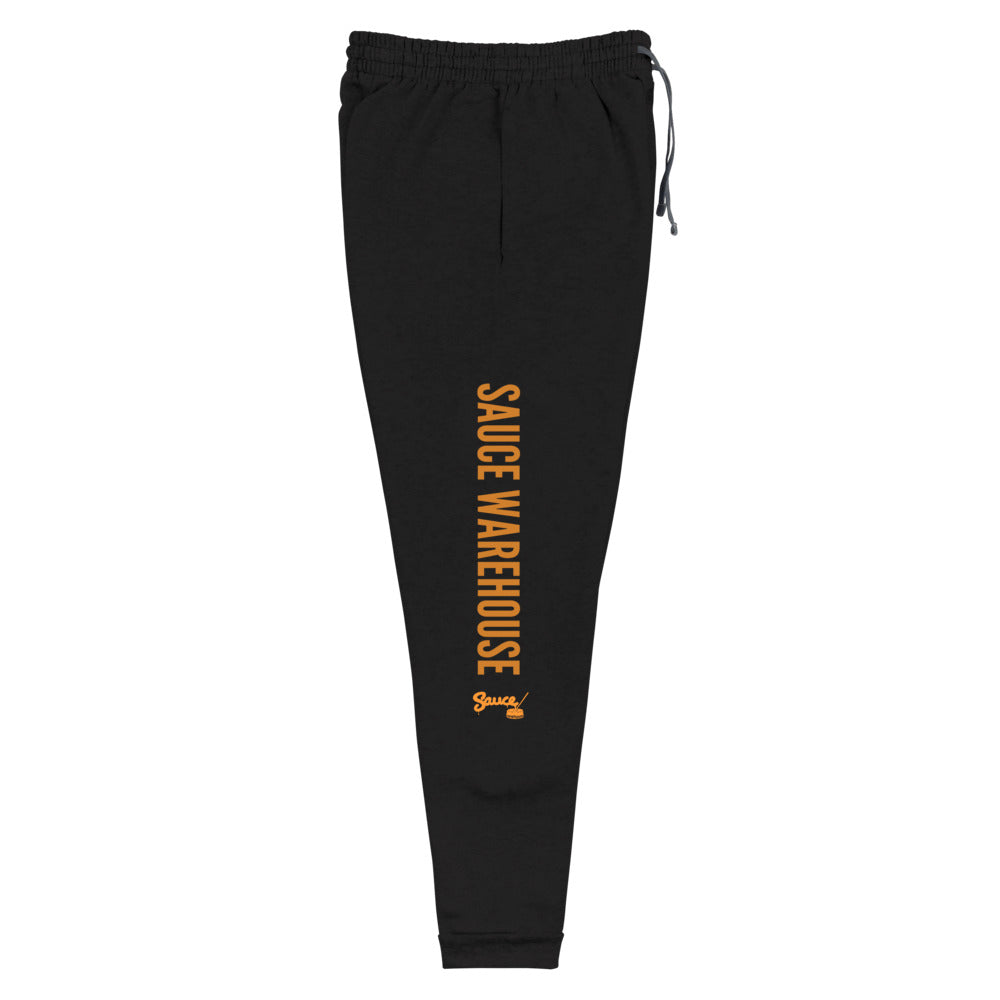 Black Sauce Warehouse x Jerzeez joggers. The outside of each leg features a Sauce Warehouse logo with &quot;Sauce Warehouse&quot; printed along the outside of the leg. Shop CBD concentrates, clothing, and dabbing accessories at Sauce Warehouse